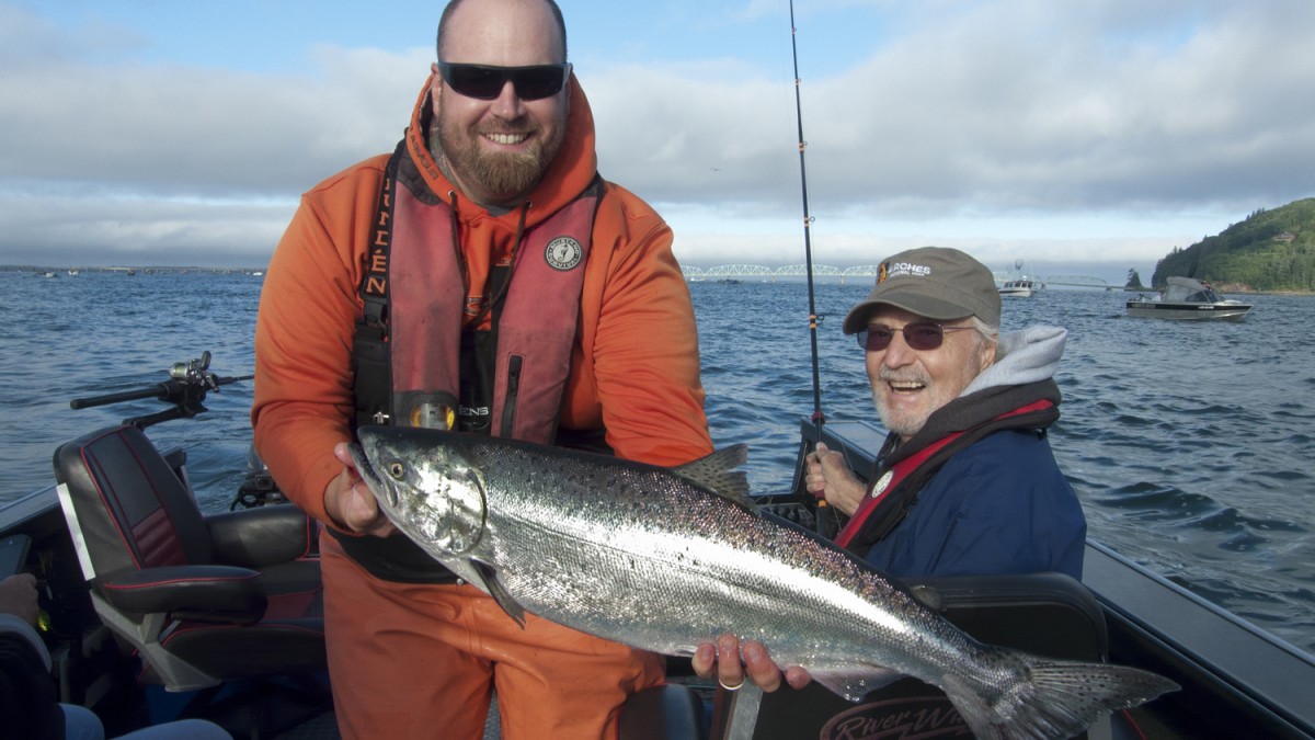 Dustin Stansbury displays a mint-bright fall chinook salmon from the Columbia River.